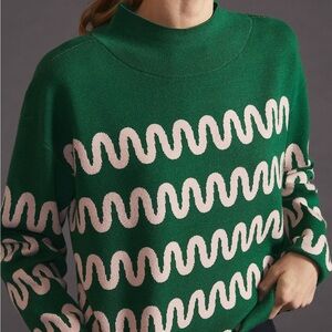 Anthropologie mock-neck sweater in green with a light pink wave pattern
